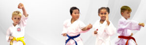 Young martial arts students wearing uniforms practicing punches in a karate class